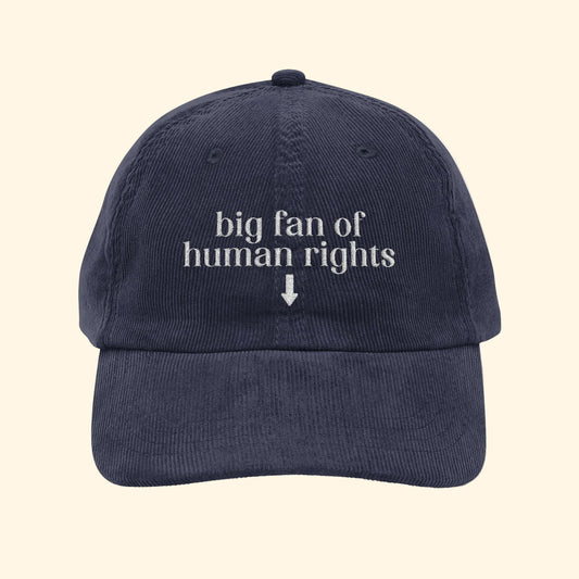 Navy blue cap with 'big fan of human rights' text on a white background