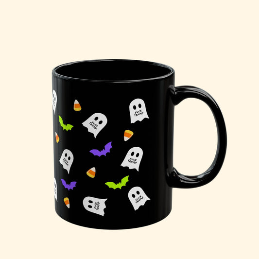 Black mug with Halloween-themed designs on a white background