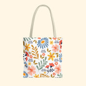 Tote bag with floral design and 'F*ck Trump' text on a white background