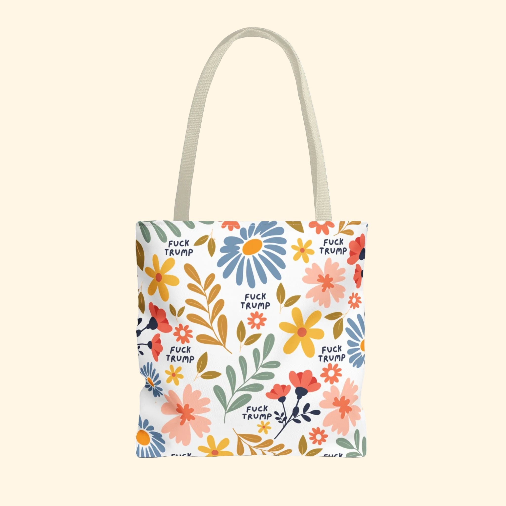 Tote bag with floral design and 'F*ck Trump' text on a white background