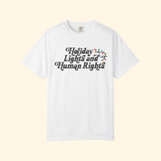 White t-shirt with 'Holiday Lights and Human Rights' text on a white background