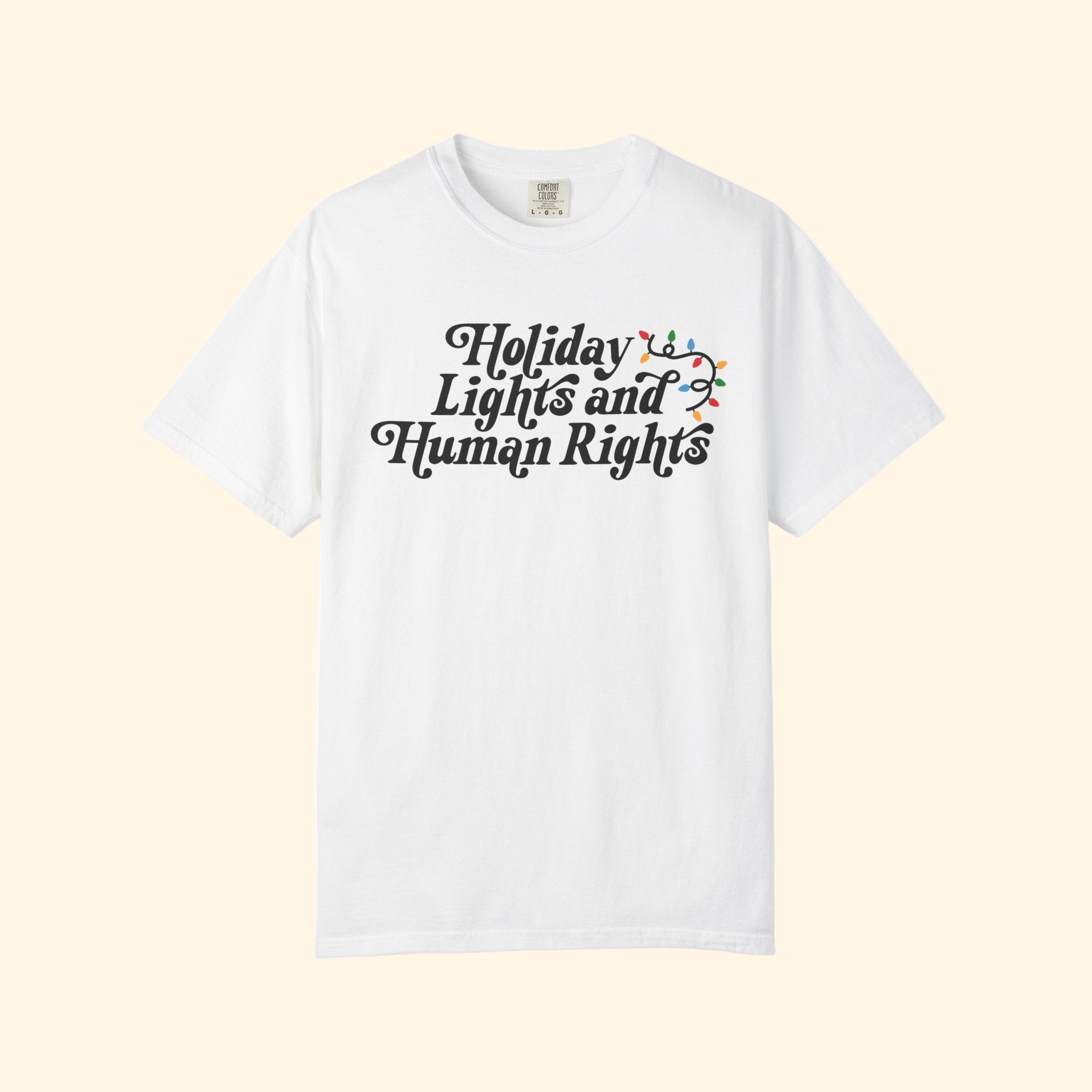 White t-shirt with 'Holiday Lights and Human Rights' text on a white background