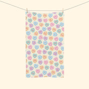 Tea towel with colorful candy heart pattern on a white background