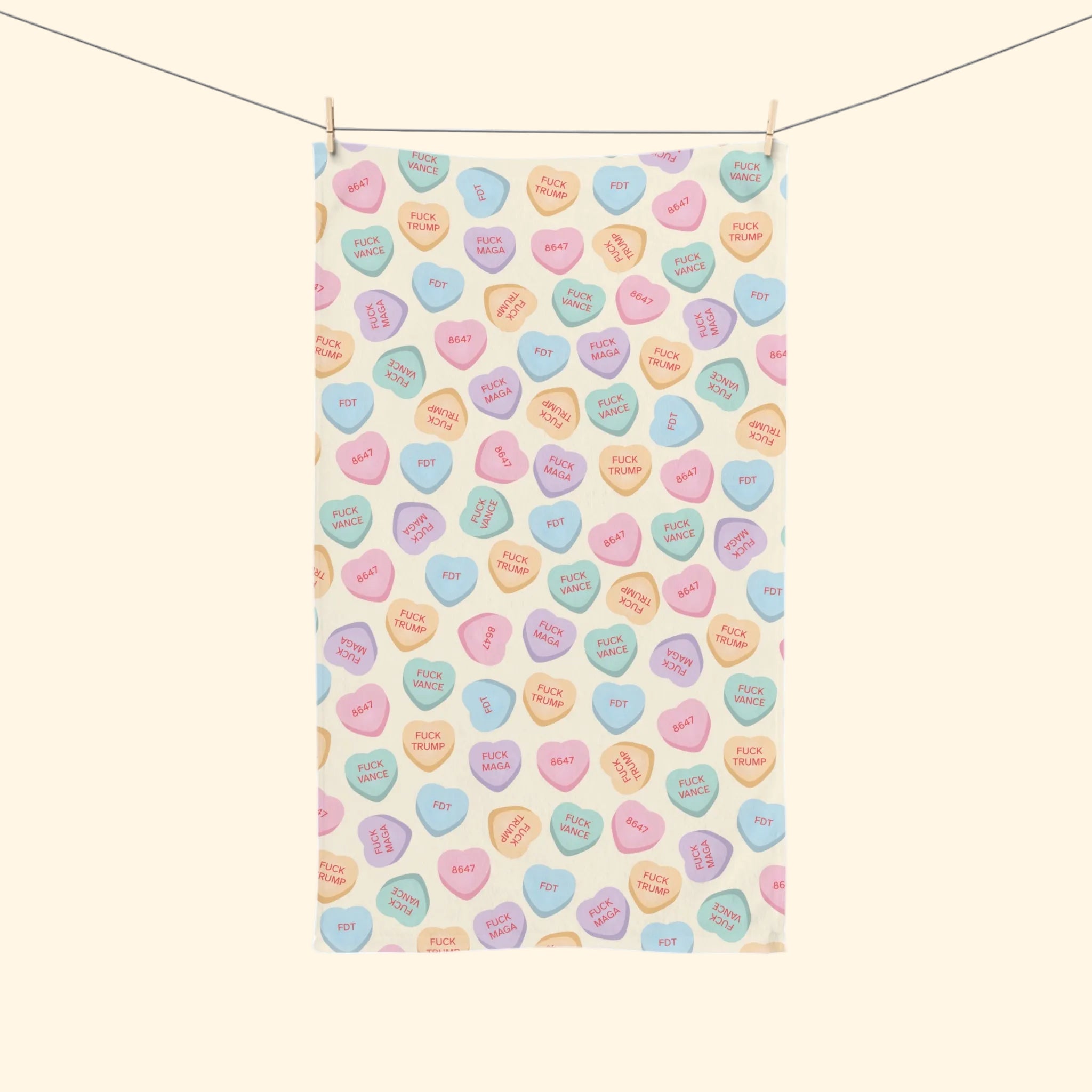 Tea towel with colorful candy heart pattern on a white background