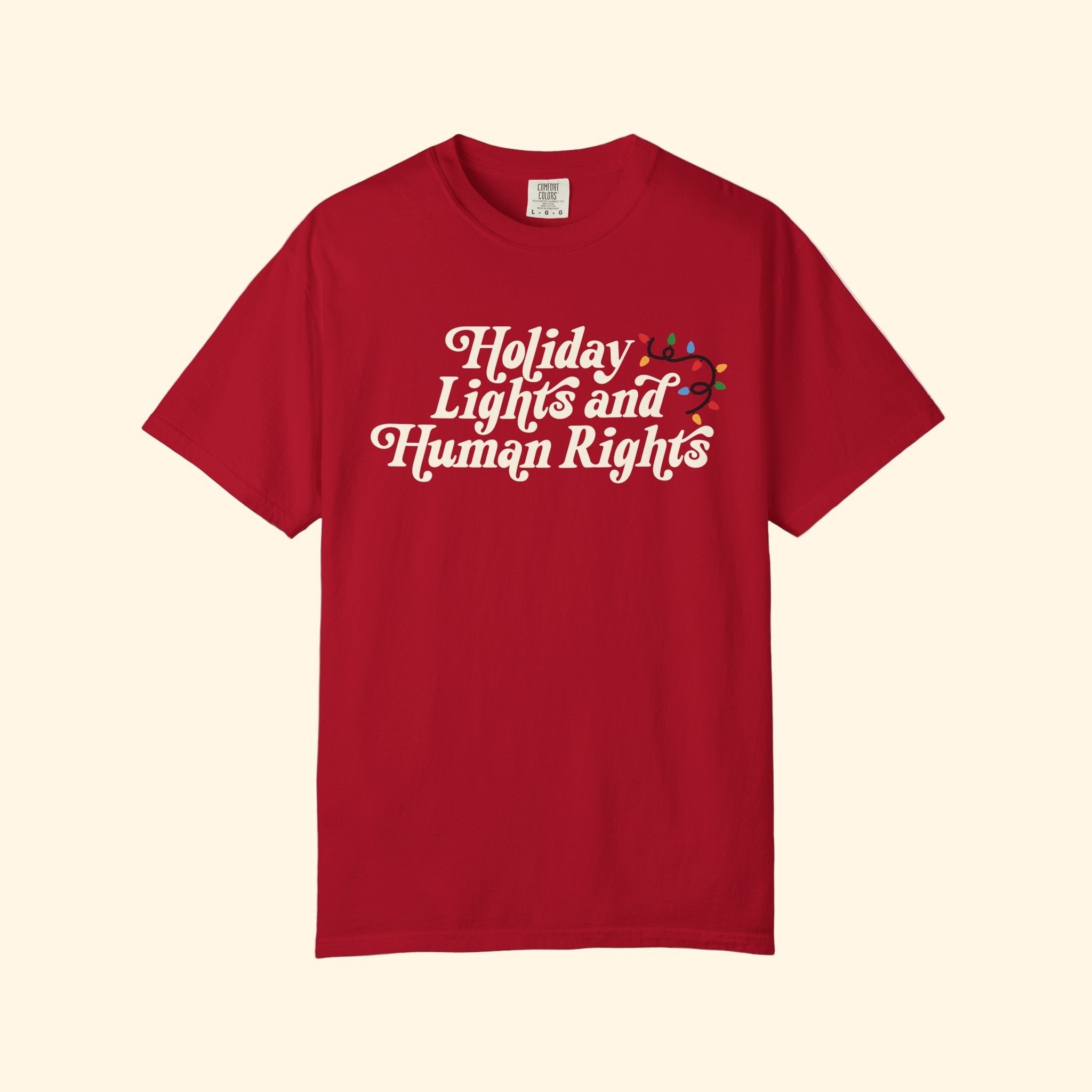 Red t-shirt with 'Holiday Lights and Human Rights' text on a white background