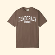 Brown t-shirt with 'DEMOCRACY EST 1776' text on a white background