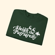 Green t-shirt with 'Sleigh the Patriarchy' text and graphic on a white background