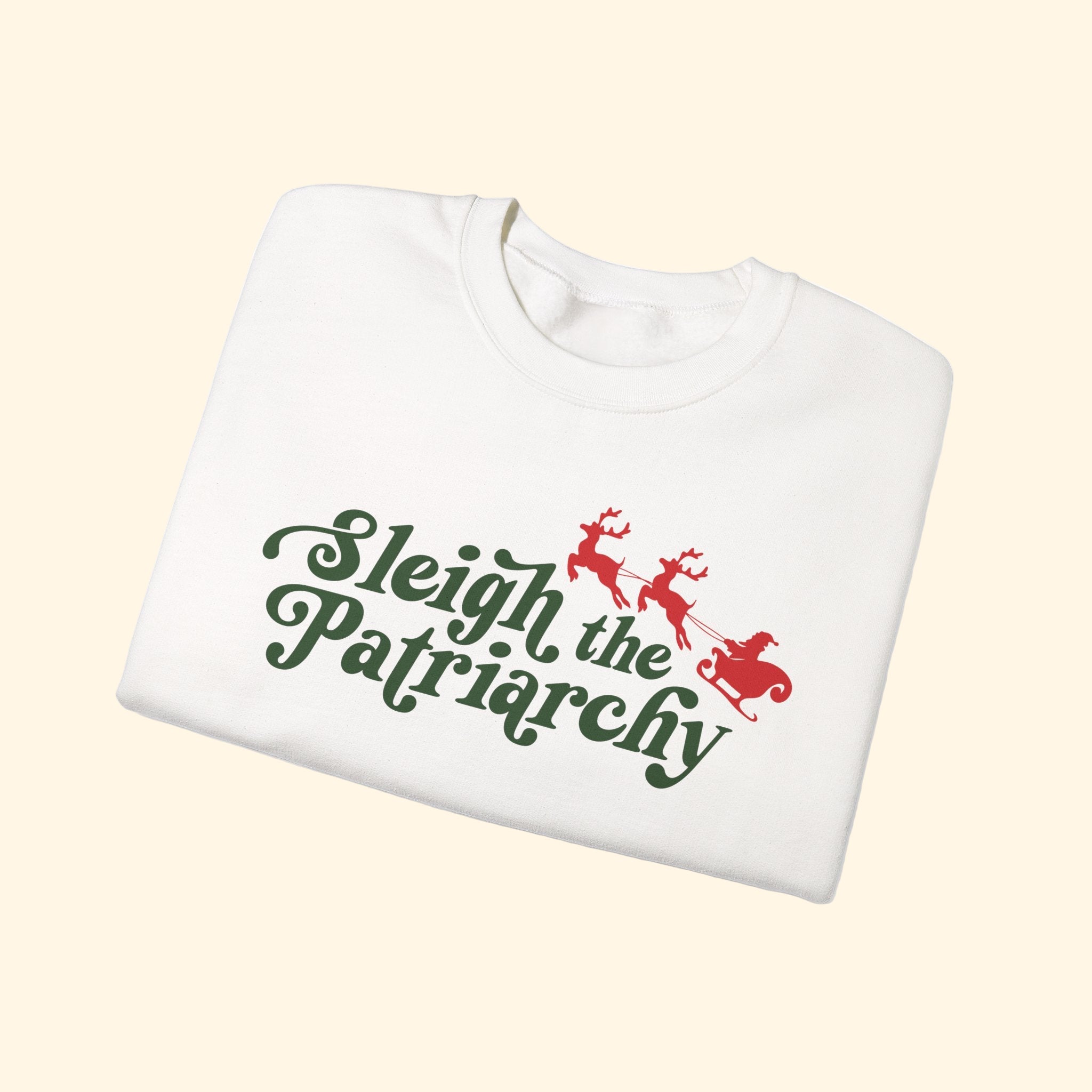White sweatshirt with 'Sleigh the Patriarchy' text and reindeer graphics on a white background