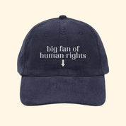 Navy blue cap with 'big fan of human rights' text on a white background