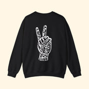 Black sweatshirt with a white peace sign graphic on the back against a white background