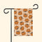 Garden flag with pumpkin pattern on a checkered background, attached to a black flagpole.