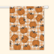Garden flag with pumpkins on a checkered pattern