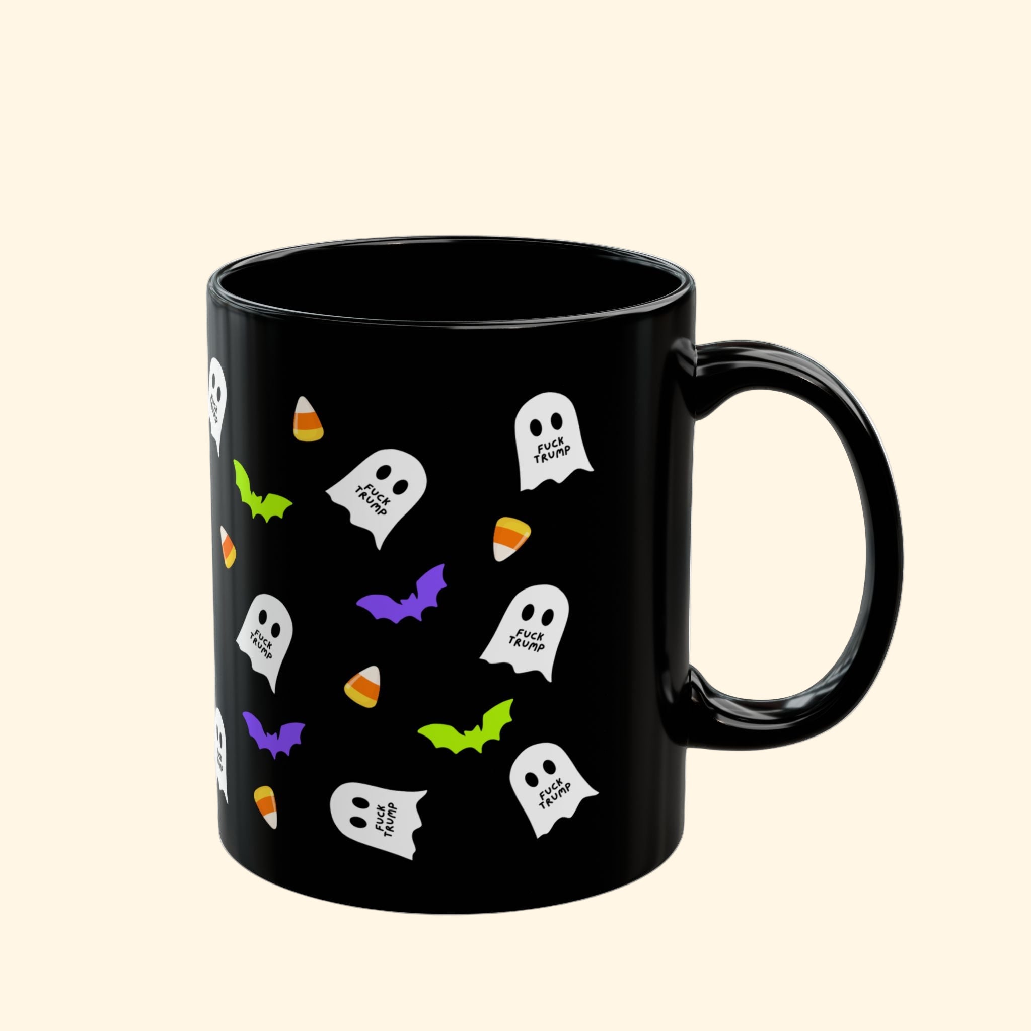 Black mug with Halloween-themed designs on a white background