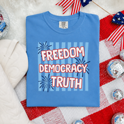 Blue t-shirt with 'Freedom Democracy Truth' text on a red, white, and blue background.