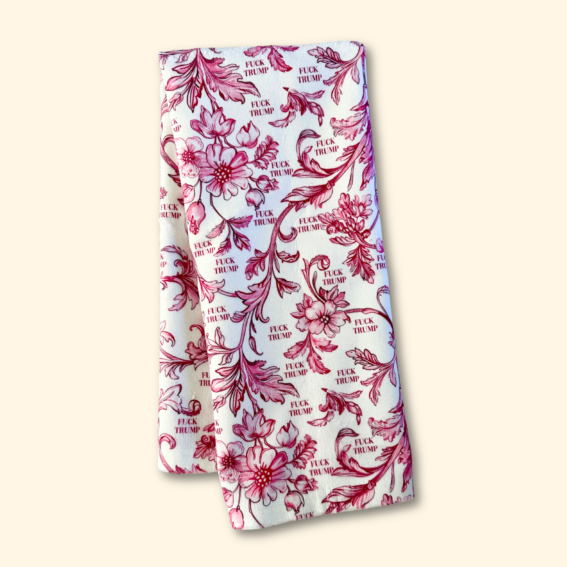 Floral patterned product with 'F*ck Trump' text on a white background
