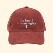 Red cap with 'big fan of human rights' text on a white background