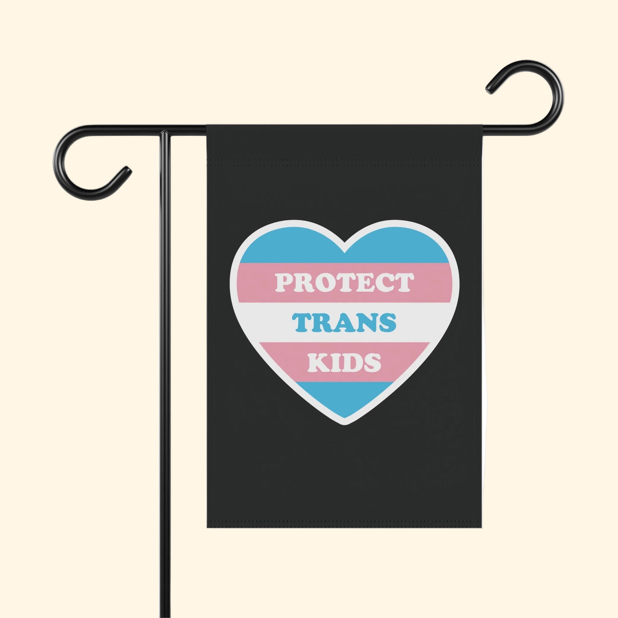 Flag with a heart design and text 'PROTECT TRANS KIDS' on a black background