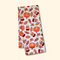 Folded towel with autumn-themed pattern featuring pumpkins and mugs on a beige background