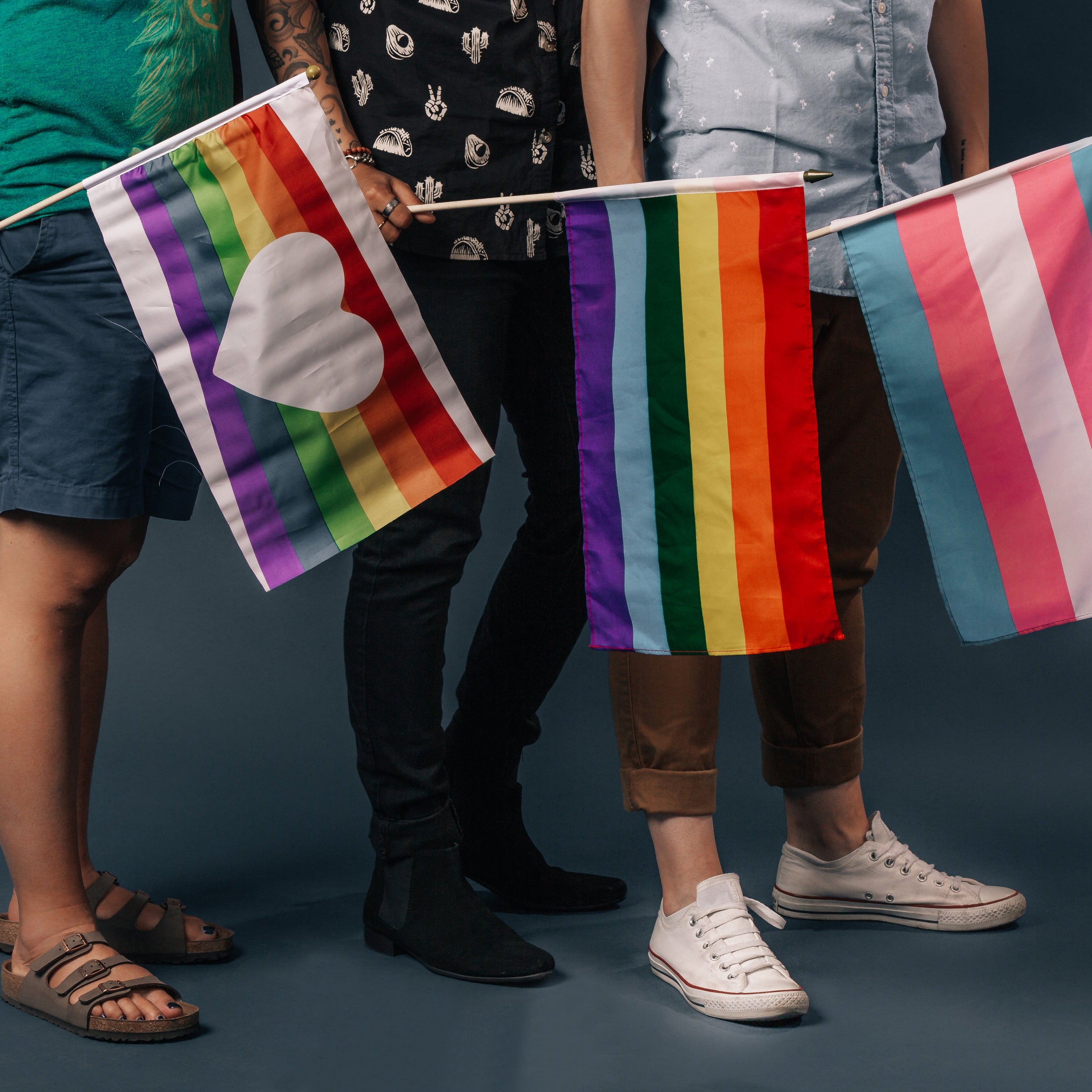 three-people-holding-pride-flags-feet.jpg